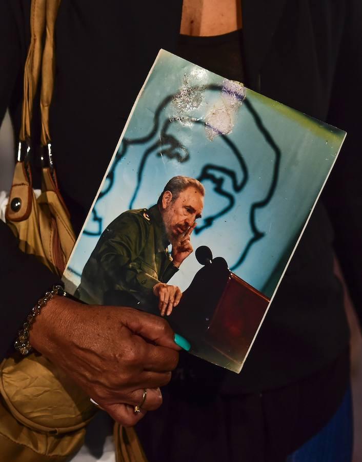 Una mujer porta una foto de Fidel mientras espera su turno en el Memoria José Martí para despedir a Fidel Castro. AFP