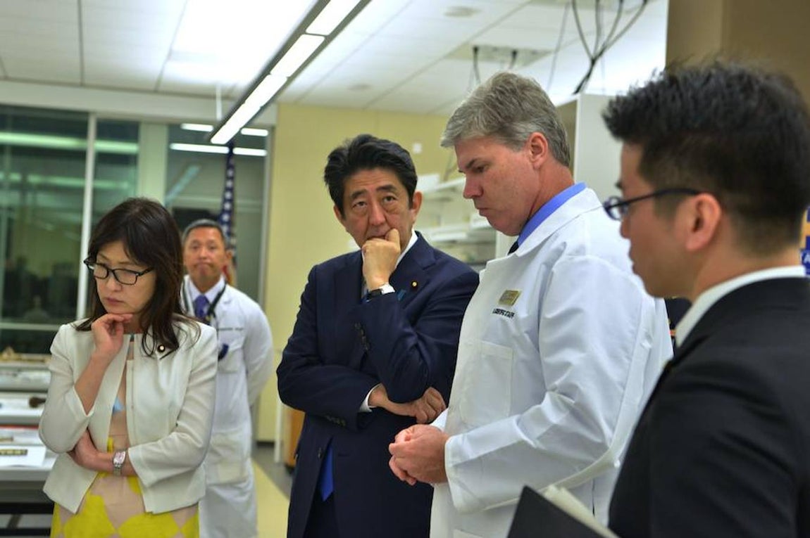 Las imágenes más destacadas de la histórica visita del primer ministro japonés a la Base de Pearl Harbor. El primer ministro de Japón y la titular de Defensa (izquierda) escuchan con atención de las explicaciones del doctor Dr. John Byrd (derecha), del Defense POW/MIA Accounting Agency laboratory, sobre los procesos de identificación