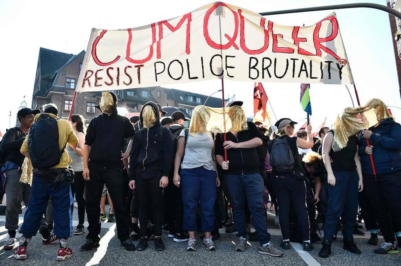 «Resistencia a la brutalidad policial». Los manifestantes exhiben una pancarta con el eslogan «Cum Quer, resist police brutality» durante el «Welcome to Hell».