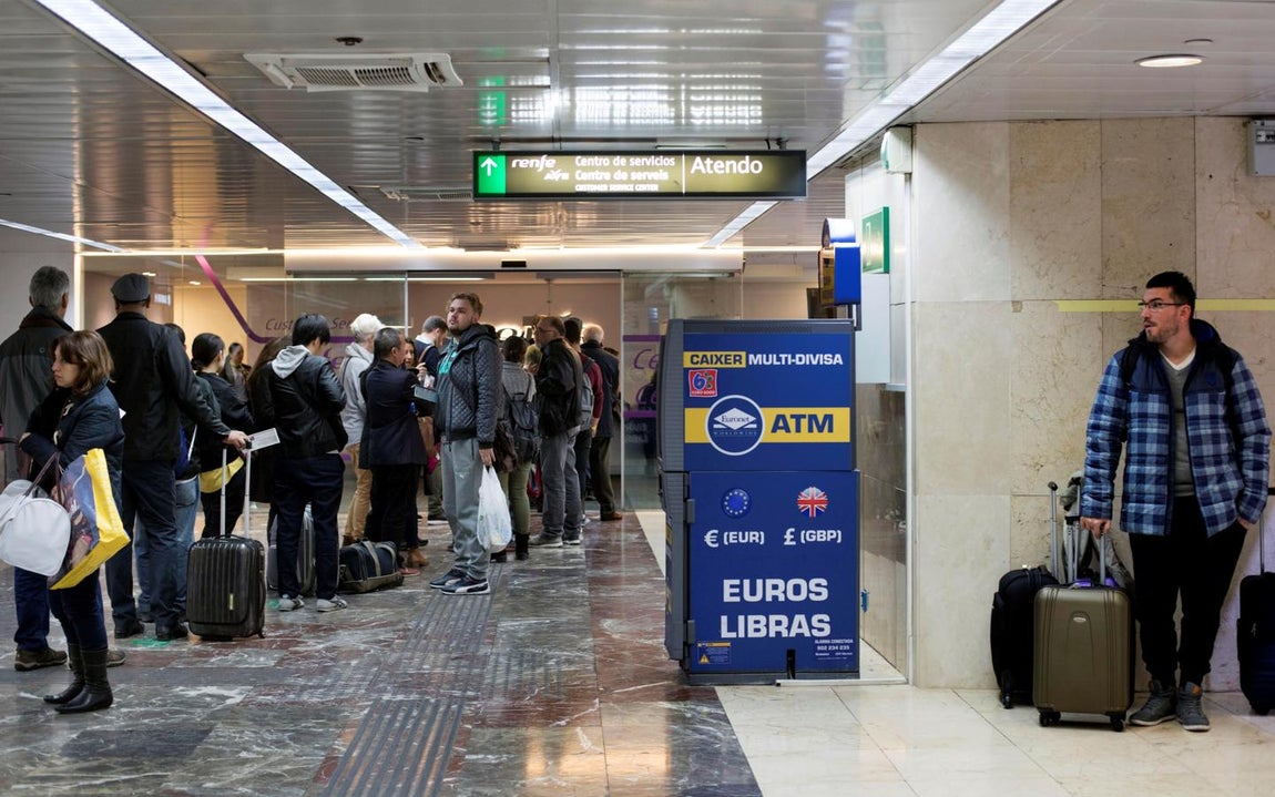 Un grupo de usuarios hace cola en la Estación de Sants de Barcelona para pedir la devolución del importe del billete por los retrasos que se están produciendo durante una nueva jornada de huelga. 