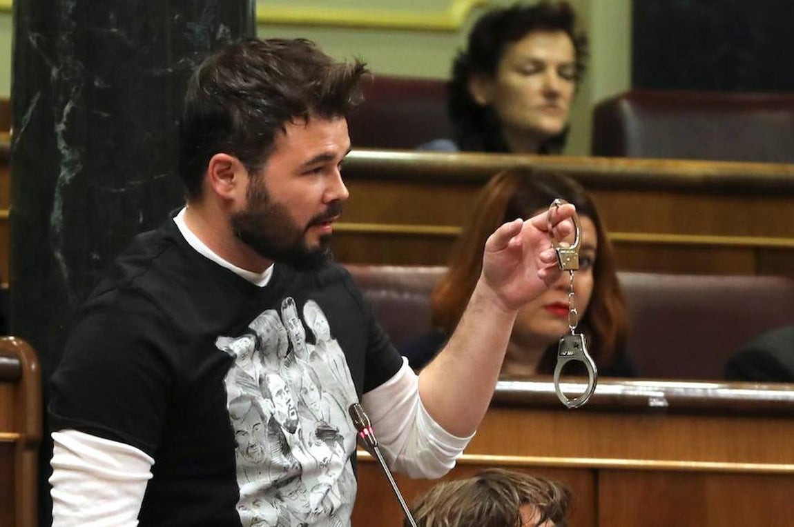Rufián exhibe unas esposas para protestar contra el encarcelamiento de ocho miembros del anterior Govern. «Ojalá M.Rajoy acabe con una de estas», dijo.. 