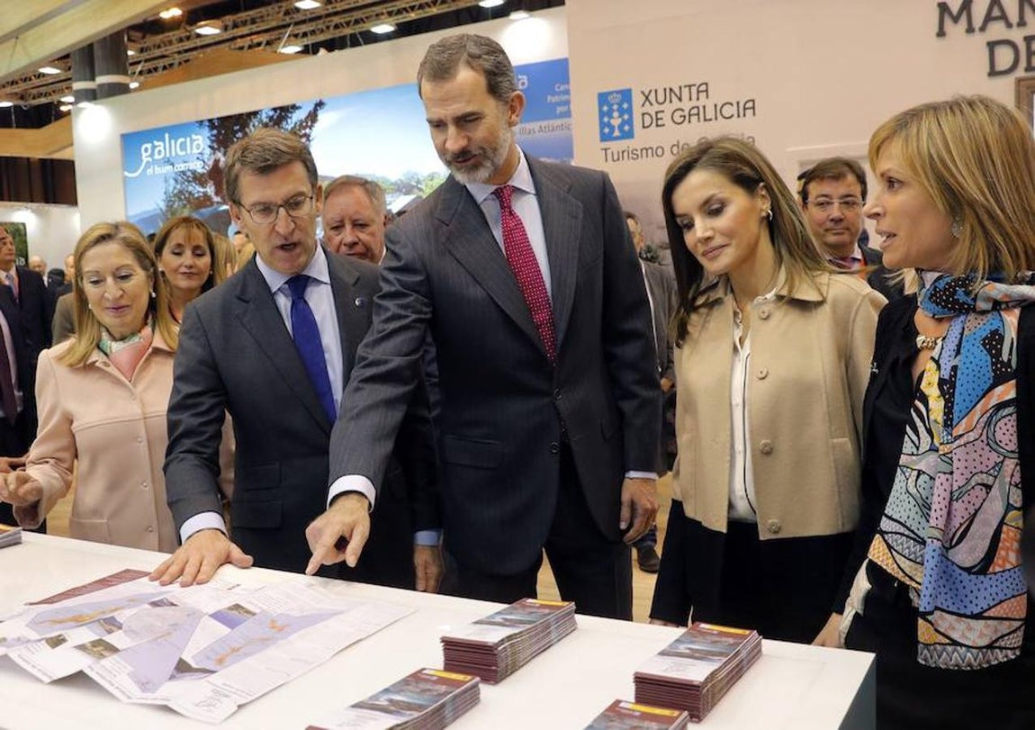 Los Reyes Felipe VI y Letizia, junto al presidente de la Xunta, Alberto Núñez Feijóo (2i), la presidenta del Congreso de los Diputados, Ana Pastor (i), y la directora de Turismo de Galicia, Nava Castro (d), durante la visita al stand de Galicia. 