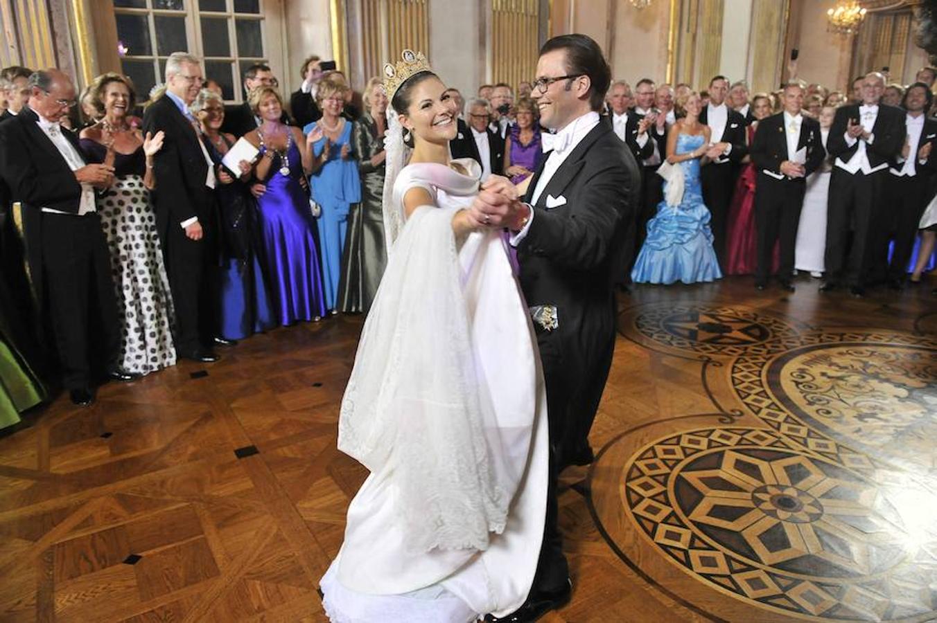 Victoria de Suecia. La heredera al trono sueco eligió para su boda al diseñador Pär Engsheden, quien creó para ella un vestido en color crema de seda duquesa satinada, con escote barco, manga corta y fajín de botones