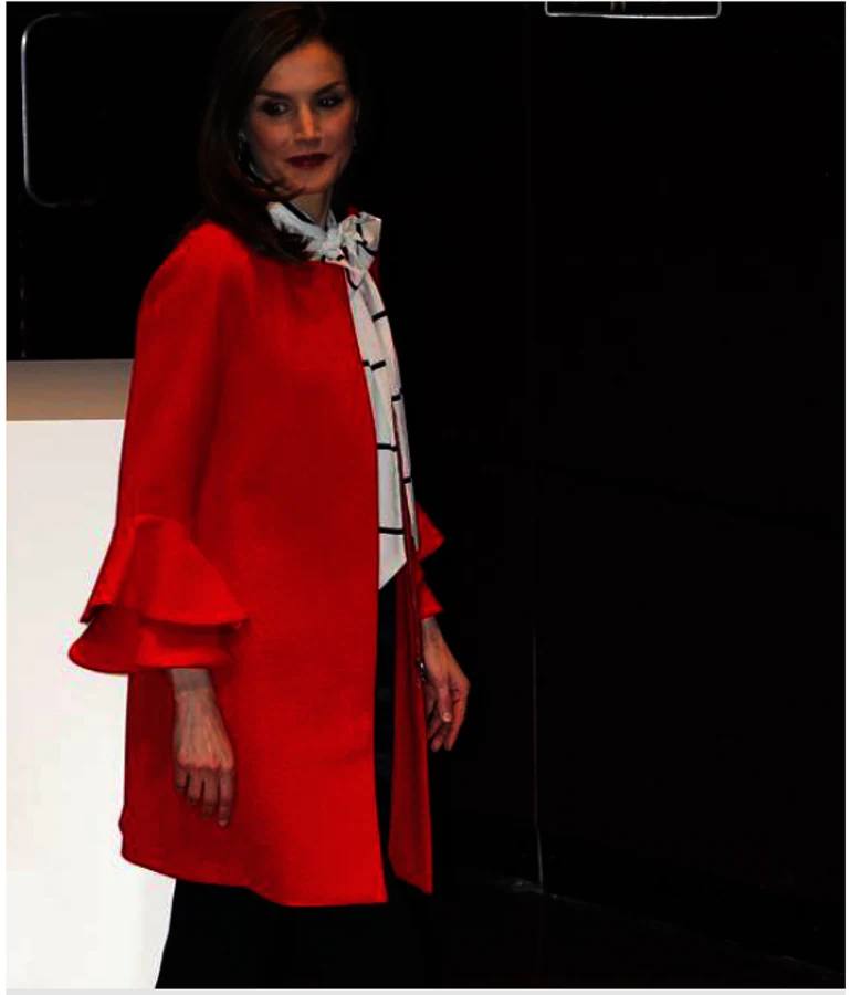 La Reina Letizia apuesta por el rojo. Se trata de un abrigo rojo de Zara con cuello redondo y manga larga con detalle de volantes en puño de 79,95 euros,