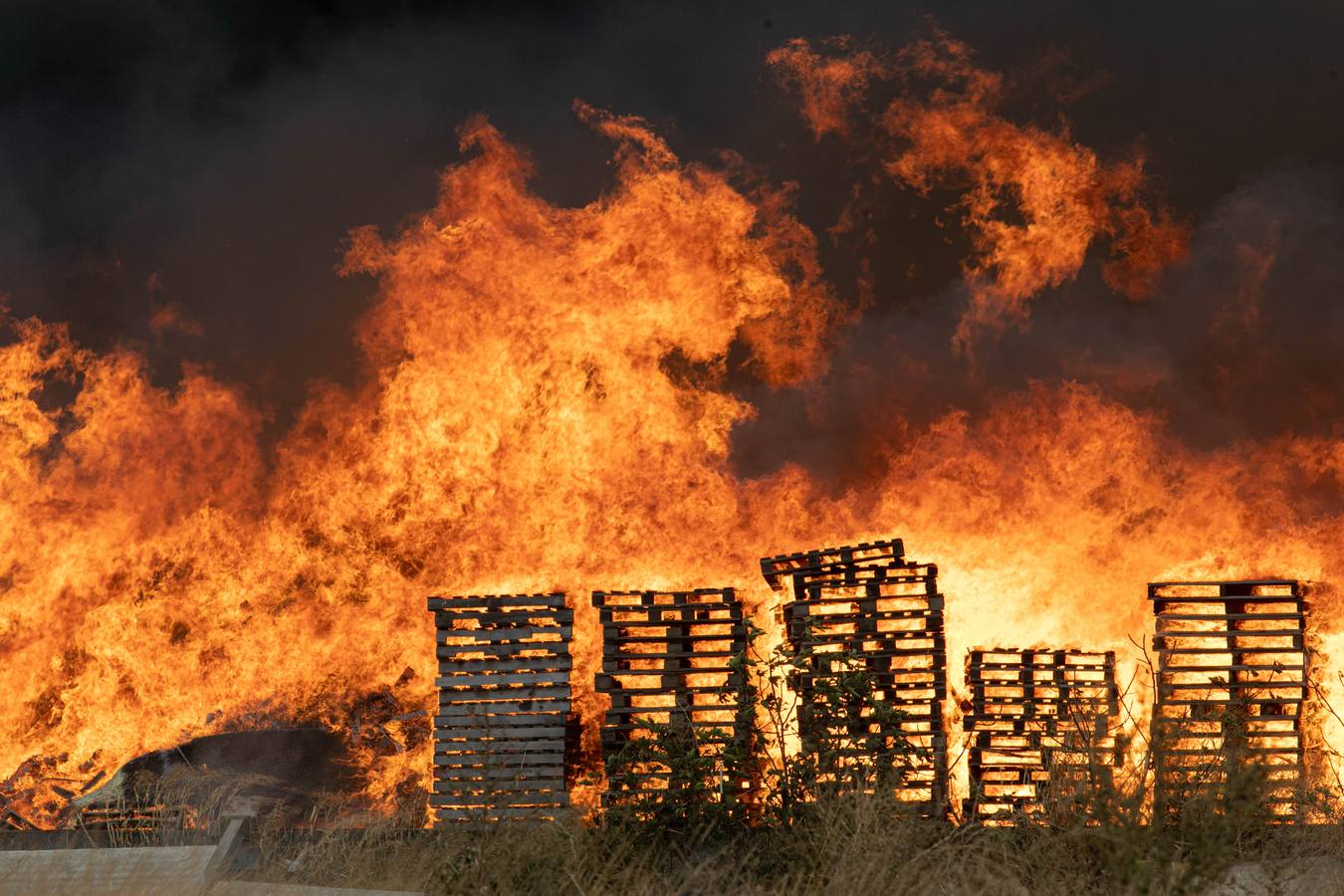 En imágenes, el incendio del patio de una nave industrial en Dos Hermanas