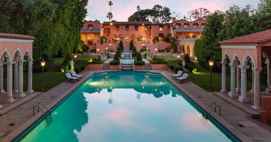 The Beverly House. La mansión es la obra maestra del arquitecto Gordon Kaufmann, que la construyó en forma de H y convirtió elementos como las largas columnatas, los balcones, ventanas arqueadas de suelo  a techo y espacios cavernosos en las señas de identidad de la mansión icónica de la época dorada de Hollywood