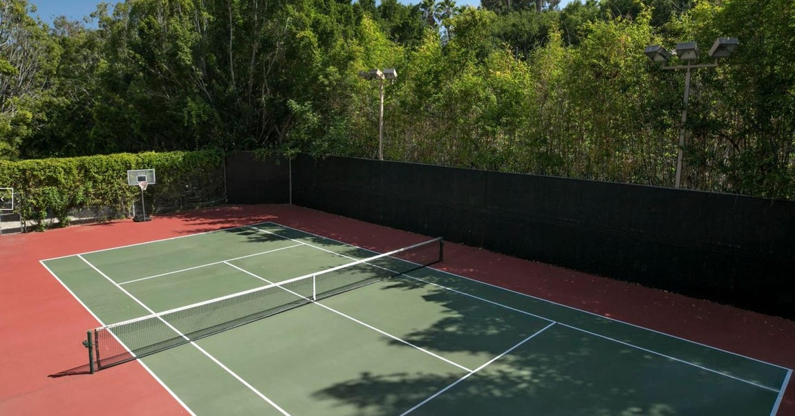 The Beverly House. En la mansión hay una cancha de tenis de proporciones olímpicas, está situada en una rona de la finca. Rodeada de vergetación, que en la mansión cumple una doble función: por un lado la refresca y, por el otro, la aísla del exterior. Desde el portal inmobiliario aseguran que es "una oportunidad única para los coleccionistas de arquitectura" porque es "la casa más emblemática de Los Angeles"