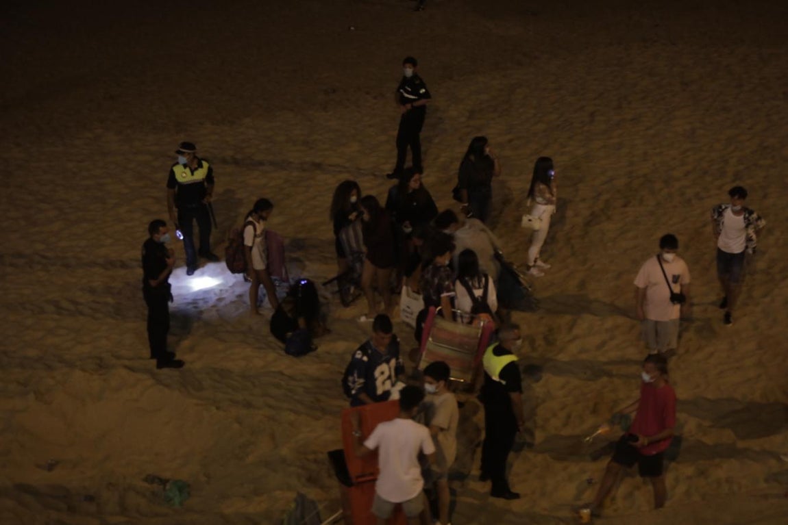 FOTOS: Unos 1.000 jóvenes son desalojados de la playa en Cádiz cuando hacían botellón por San Juan