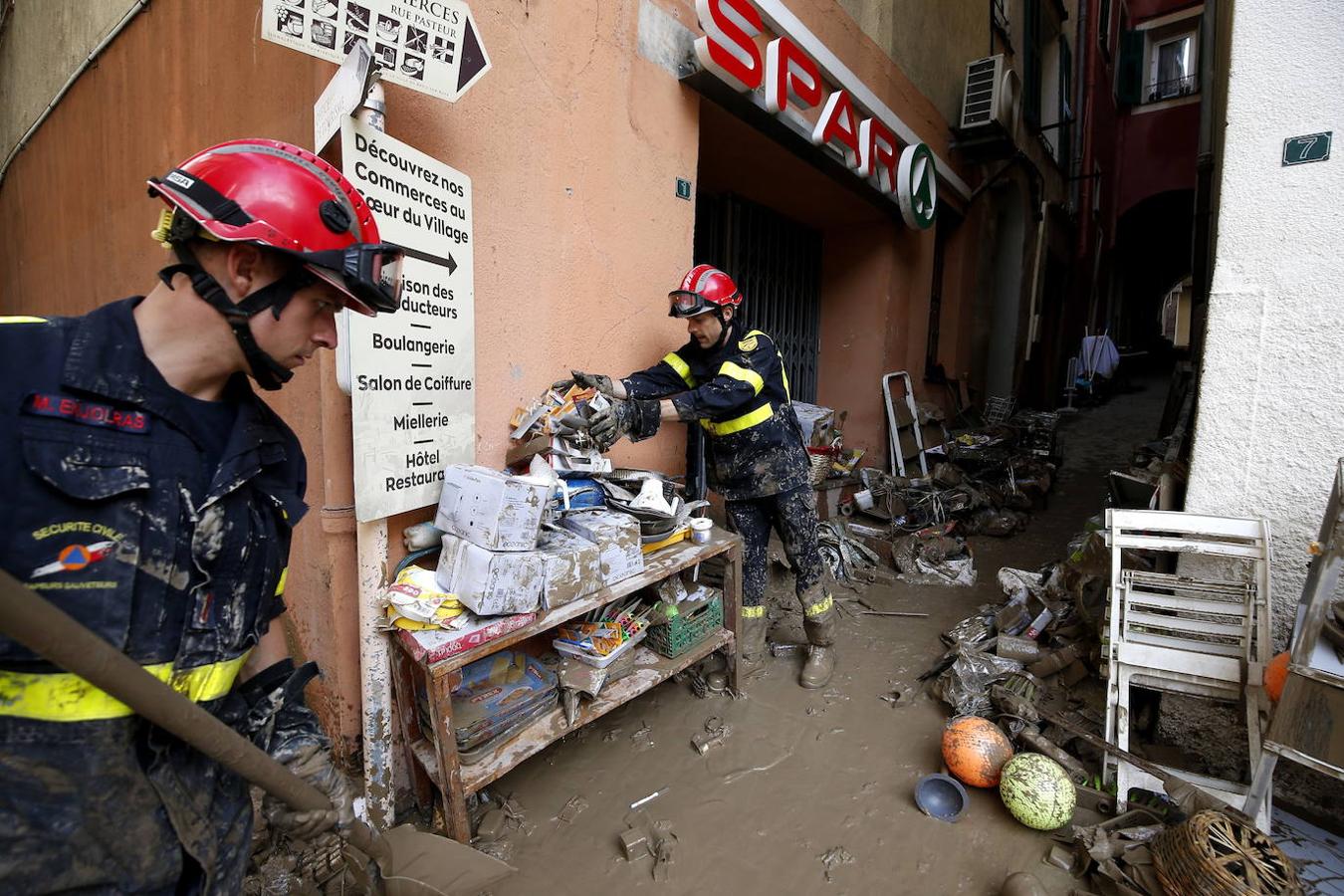 Bomberos franceses realizan trabajos de limpieza en las calles y tiendas inundadas por la tormenta.. 