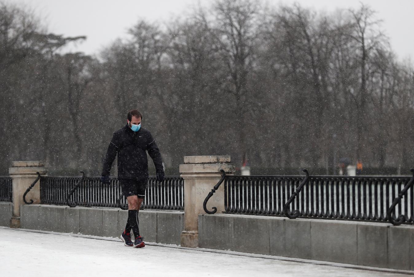 Bajas temperaturas. Un hombre hace deporte mientras nieva en el parque del Retiro. Las temperaturas que traerá consigo la borrasca Filomena durante los próximos días podrán alcanzar los seis grados bajo cero.