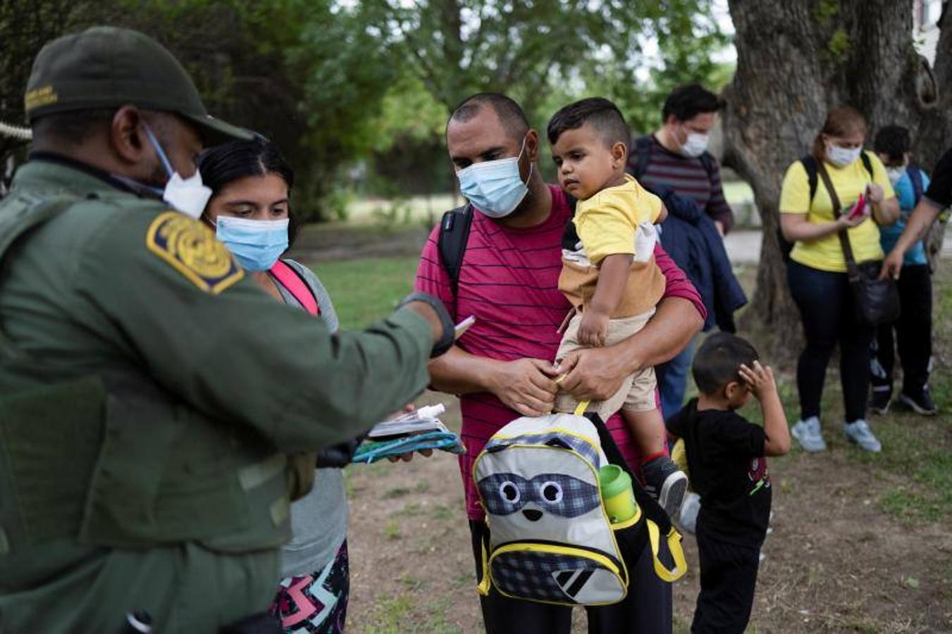Una familia en busca de asilo, a la espera de ser transportada por la patrulla fronteriza de EE.UU.. 