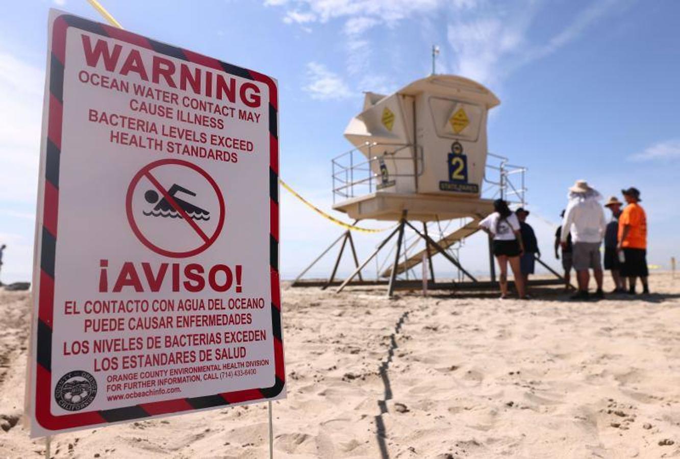 Agua contaminada. Carteles advierten en inglés y español del cierre de las playas y del peligro de bañarse en las aguas contaminadas por el petróleo