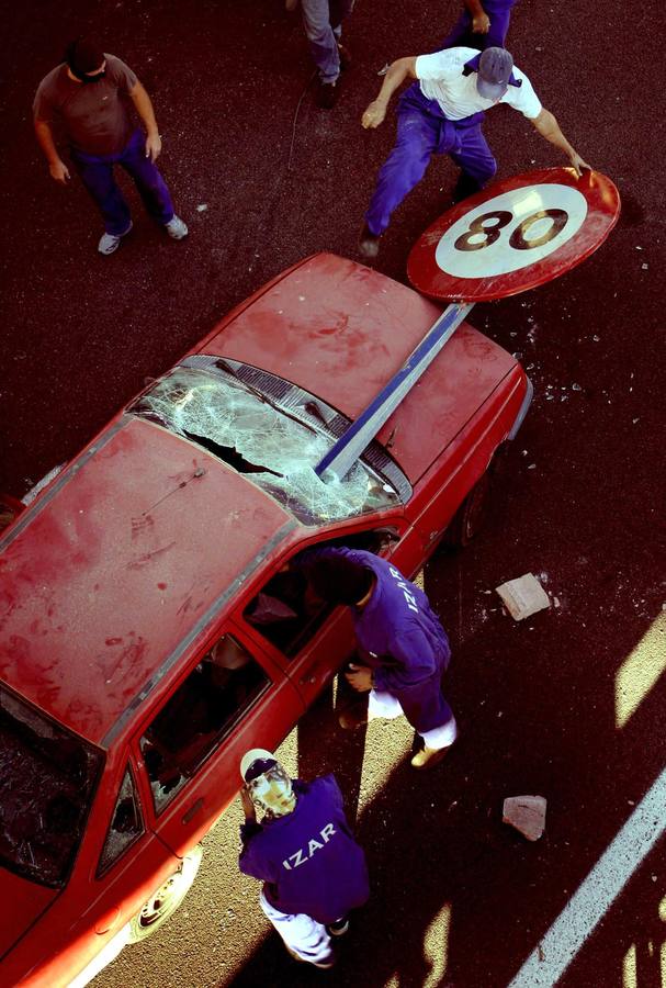 Trabajadores del grupo público Izar destruyen un automóvil durante un bloqueo, realizado en la carretera de San Fernando para protestar contra los planes de privatización parcial. 