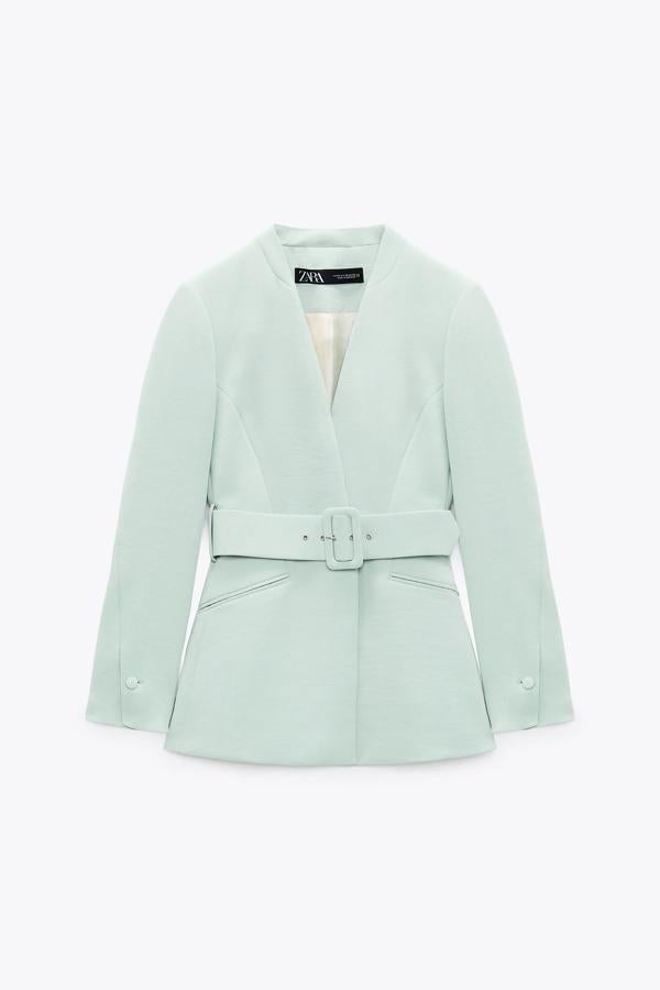 Con cinturón. Blazer sin solapa con hombros marcados y bolsillos de vivo en delantero, con cinturón con hebilla forrada de Zara. Precio: 35,99€ / antes: 49,95€