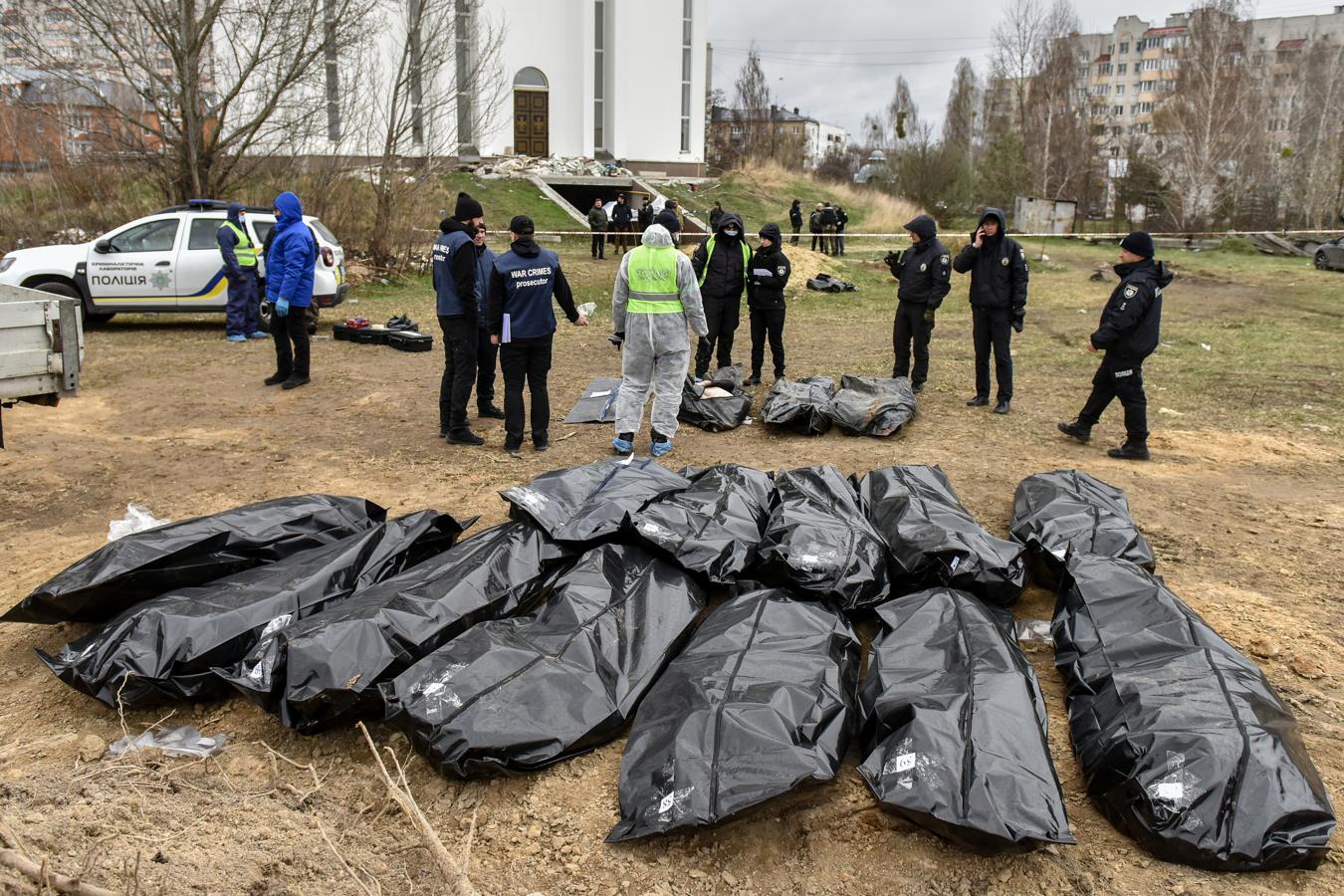 Policías forenses comienzan la recuperación de cientos de cadáveres en Bucha. 