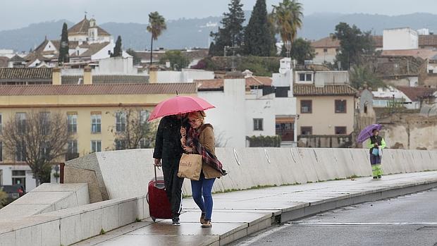 Una pareja se refugia bajo un paraguas un día de lluvia