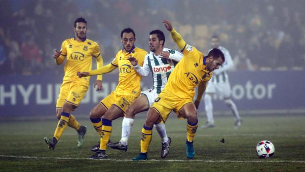 Caballero entre varios jugadores del Alcorcón en el partido de ida