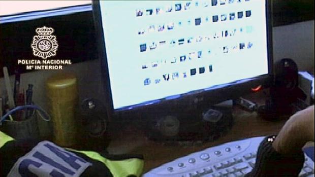 Un policía investiga el ordenador de un detenido