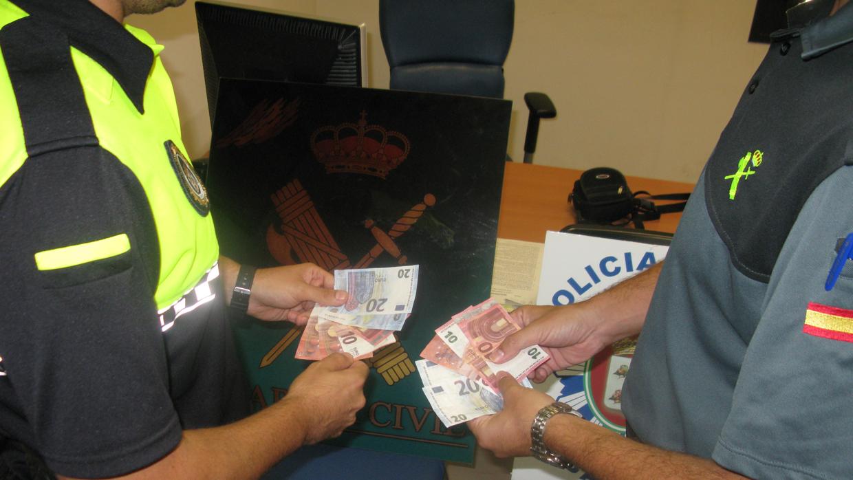 Los agentes muestran los billetes falsos que fabricaban y utilizaba la pareja de arrestados