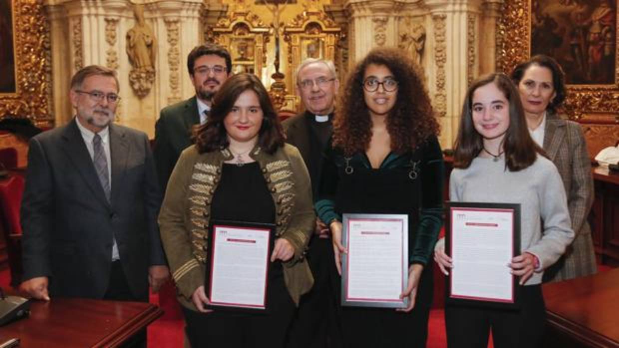 Las tres alumnas galardonadas con sus relatos enmarcados junto a los miembros del jurado en la Mezquita