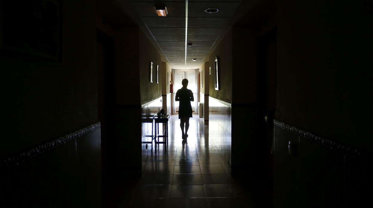 Una mujer camina por un pasillo de una clínica