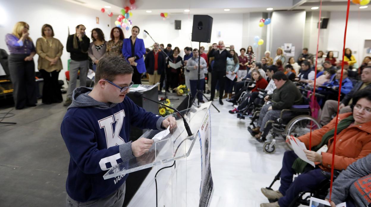 Un joven de Down Córdoba lee durante el acto del Día de la Discapacidad