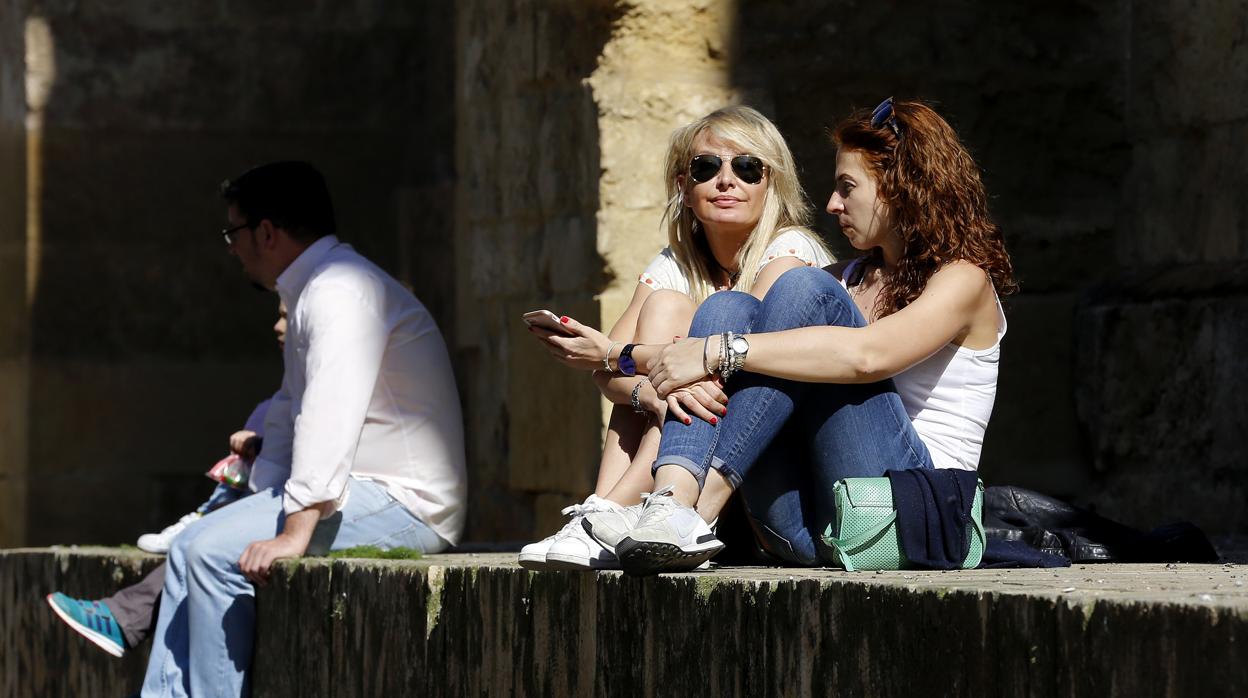 Dos mujeres descansan al sol en los alrededores de la Mezquita-Catedral