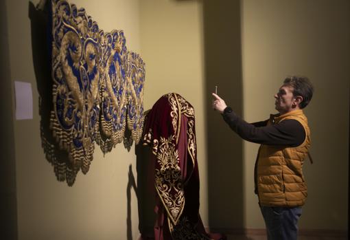 Un visitante realiza una fotografía a una bambalina frontal