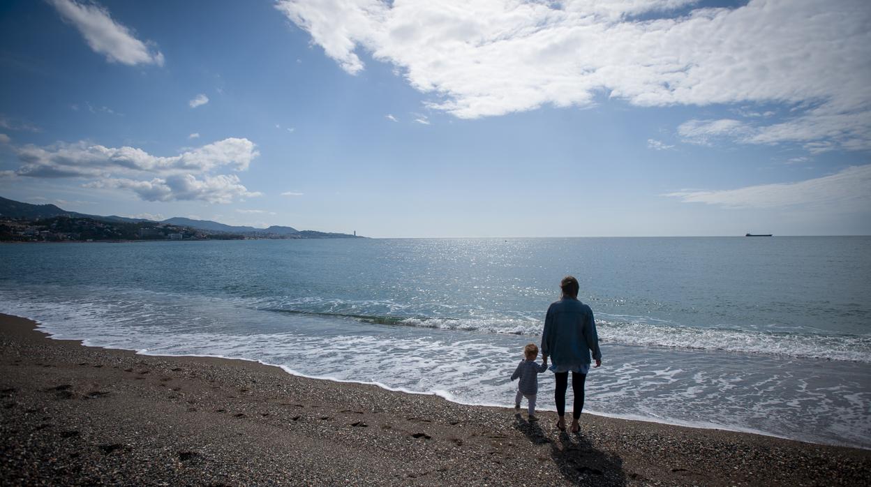 Una madre con su hijo en la playa de la Malagueta, en Málaga.