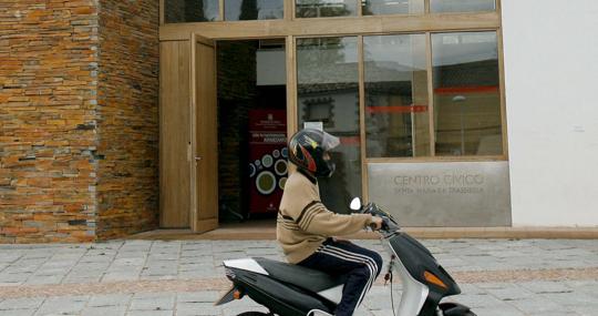 Un motorista delante el centro cívico de Santa María de Tassierra