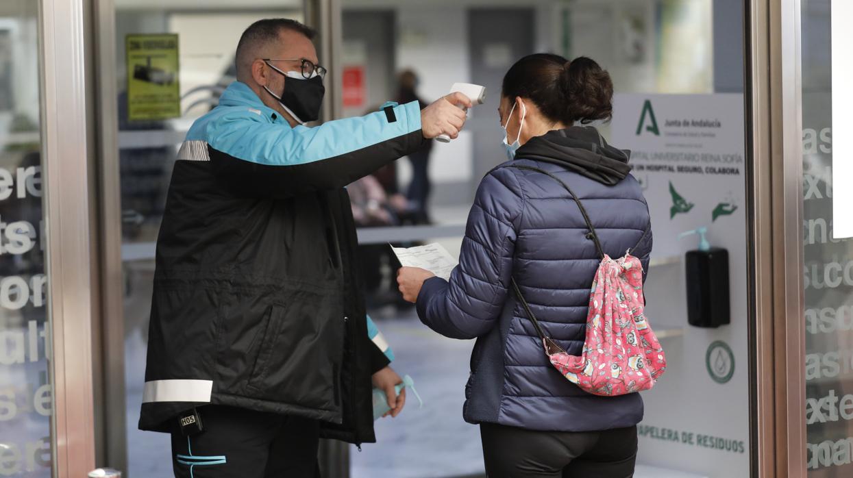 Toma de temperatura a una mujer en el acceso al hospital Reina Sofía de Córdoba