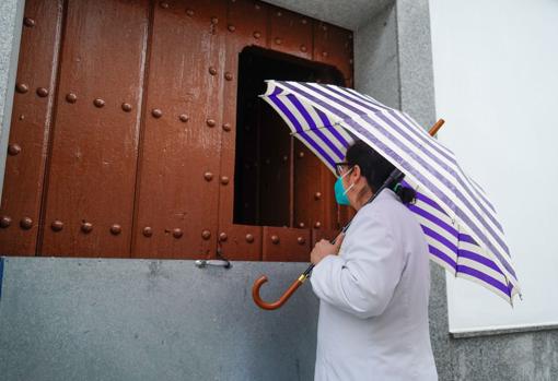 Una vecina de Añora se asoma a la puerta de una casa