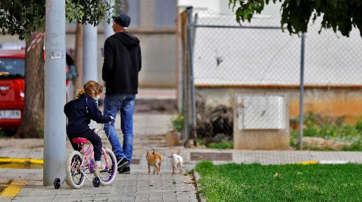 Una niña juega con su bicicleta