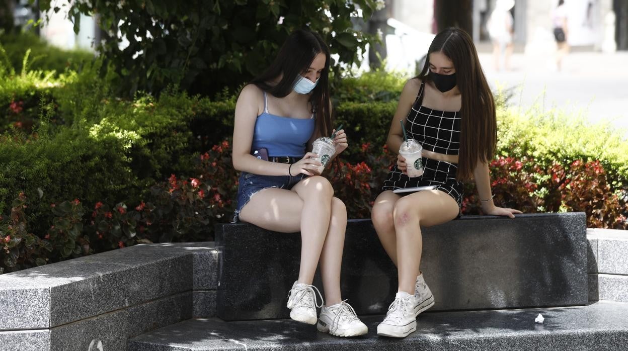 Dos jóvenes charlan en la plaza de las Tendilla durante este verano