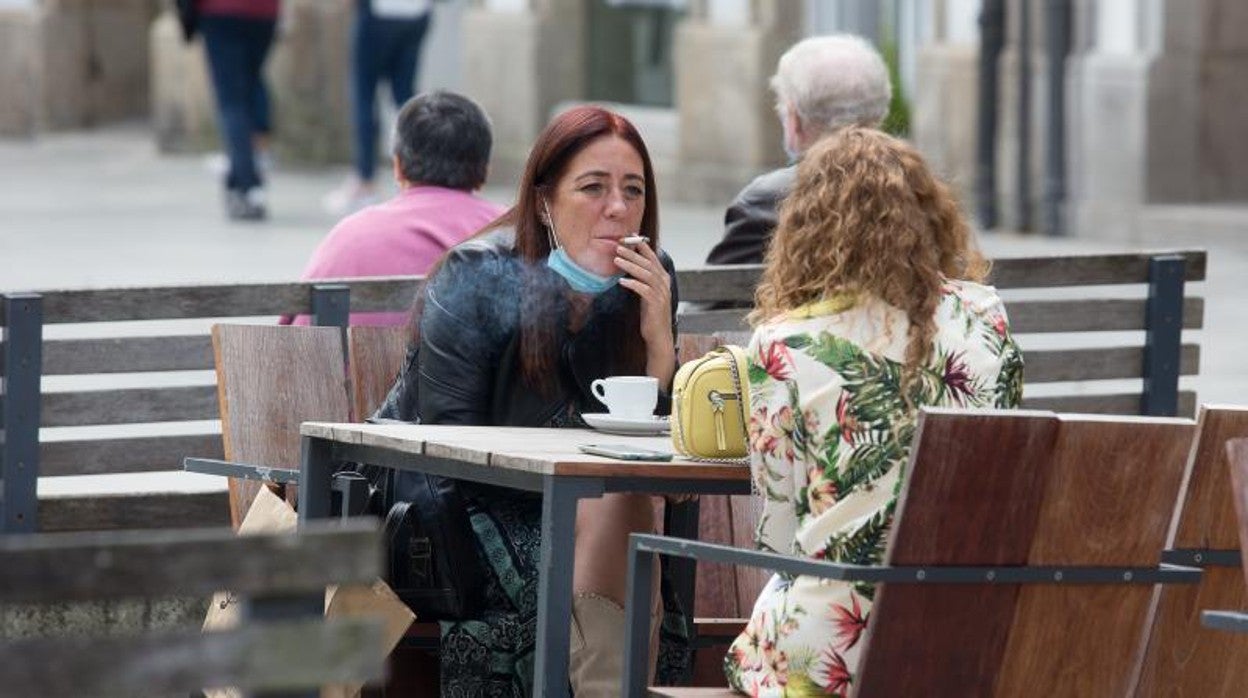 Dos mujeres fumando en una terraza