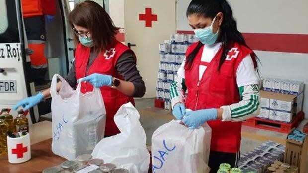 Voluntarios de Cruz Roja, organización del sector no lucrativo, preparan paquetes de alimentos para repartir a personas necesitadas.
