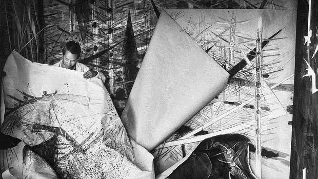 Wifredo Lam, ante una de sus obras de la serie Brousses en su taller de Albissola, Italia (1963)
