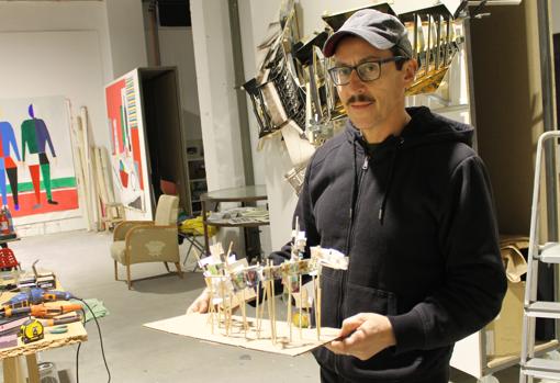 El madrileño sosteniendo la maqueta de una de sus creaciones en su espacio de trabajo