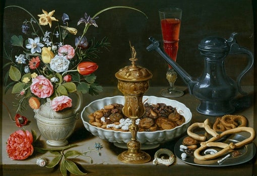 Clara Peeters. Bodehón con flores, copa de plata dorada, almendras, frutos secos, dulces, panecillos, vino y jarra de peltre. 1611. Museo del Prado. Madrid