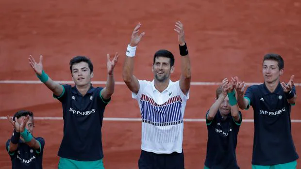 Djokovic celebra su victoria con los recogepelotas