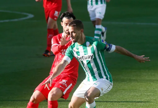 Suso y Canales pugnan por un balón durante el derbi Betis - Sevilla
