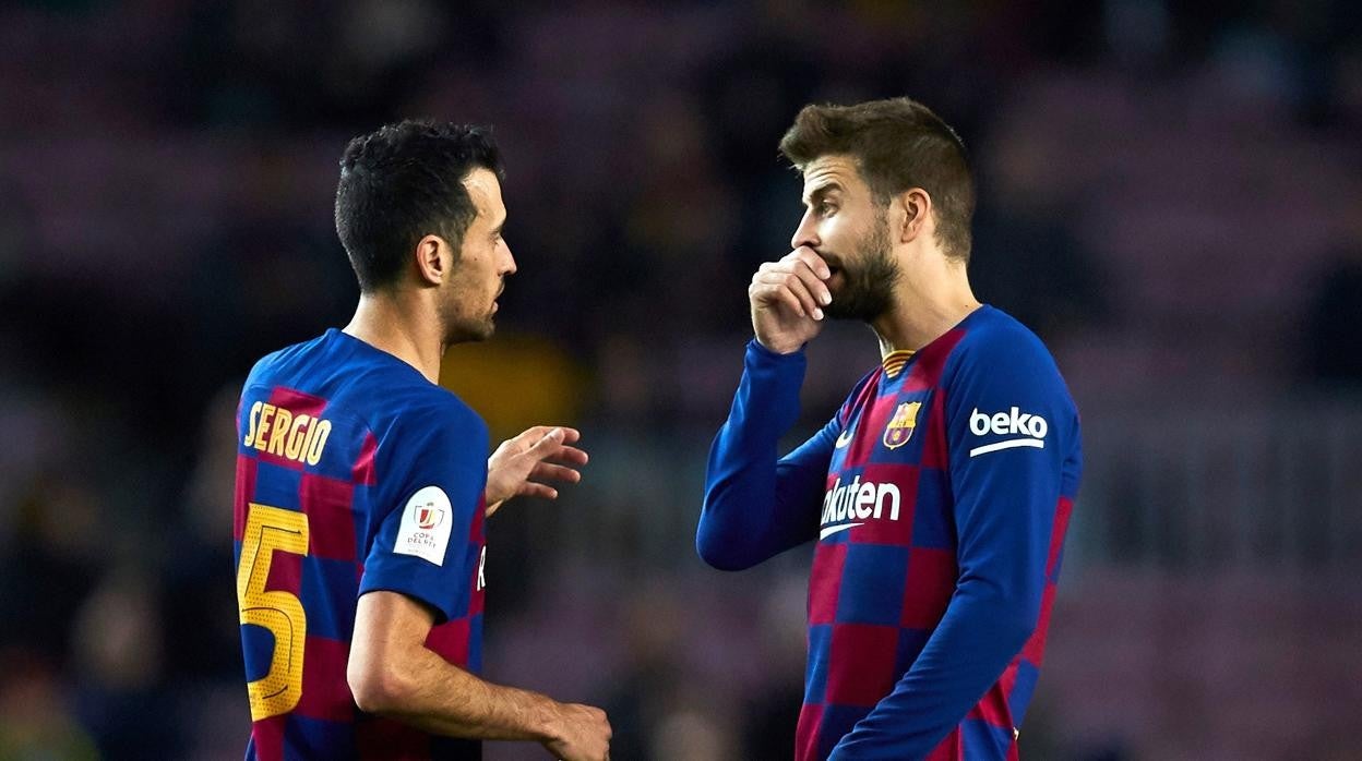 Gerard Piqué le da instrucciones a Sergio Busquets durante un partido del Barcelona