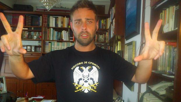 El candidato de Ciudadanos, Antonio Lodeira, alias «Toni el Serbio», posa con uno de los lemas ultra