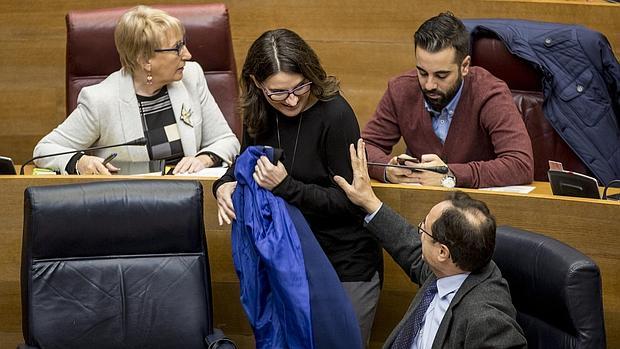 El conseller de Hacienda saluda a la vicepresidenta de la Generalitat en las Cortes