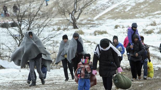 Refugiados de Siria caminan hacia un campamento temporal para inmigrantes en Serbia
