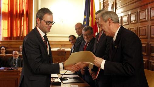 Josué López, de Santa Olalla, en el momento de recibir el título como nuevo académico de manos del concejal de Cultura de Toledo, José María González Cabezas