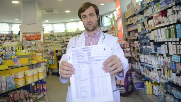 Carlos, farmacéutico de la calle La Rioja, muestra la lista de espera para la vacuna