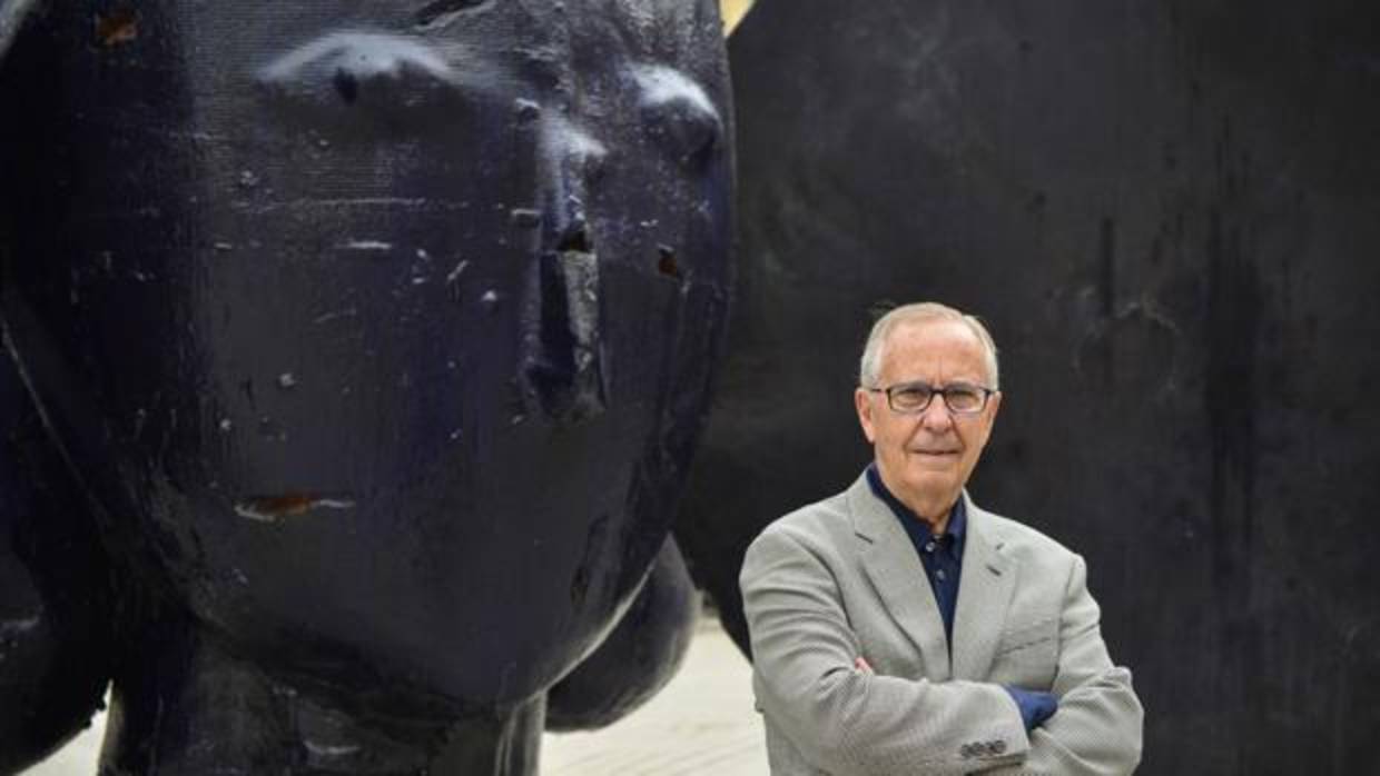 Imagen del artista Manolo Valedés frente a su escultura «Los Aretes»