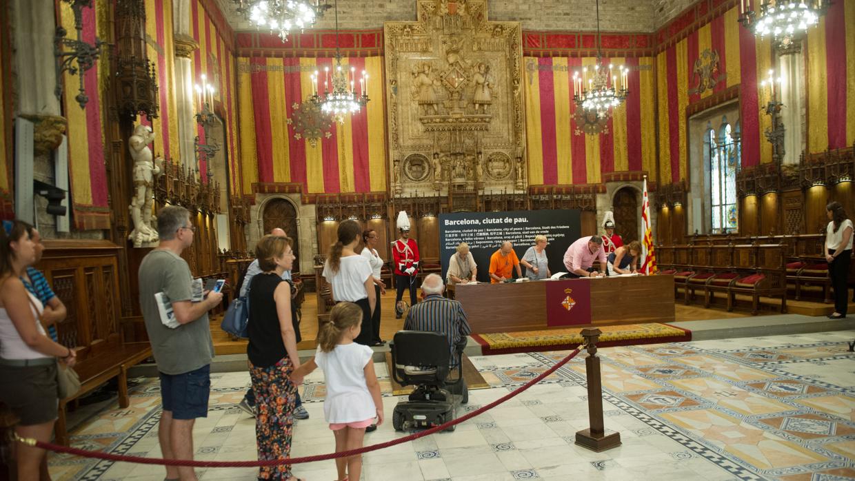 Varias personas esperan la cola para firmar en el libro de condolencias