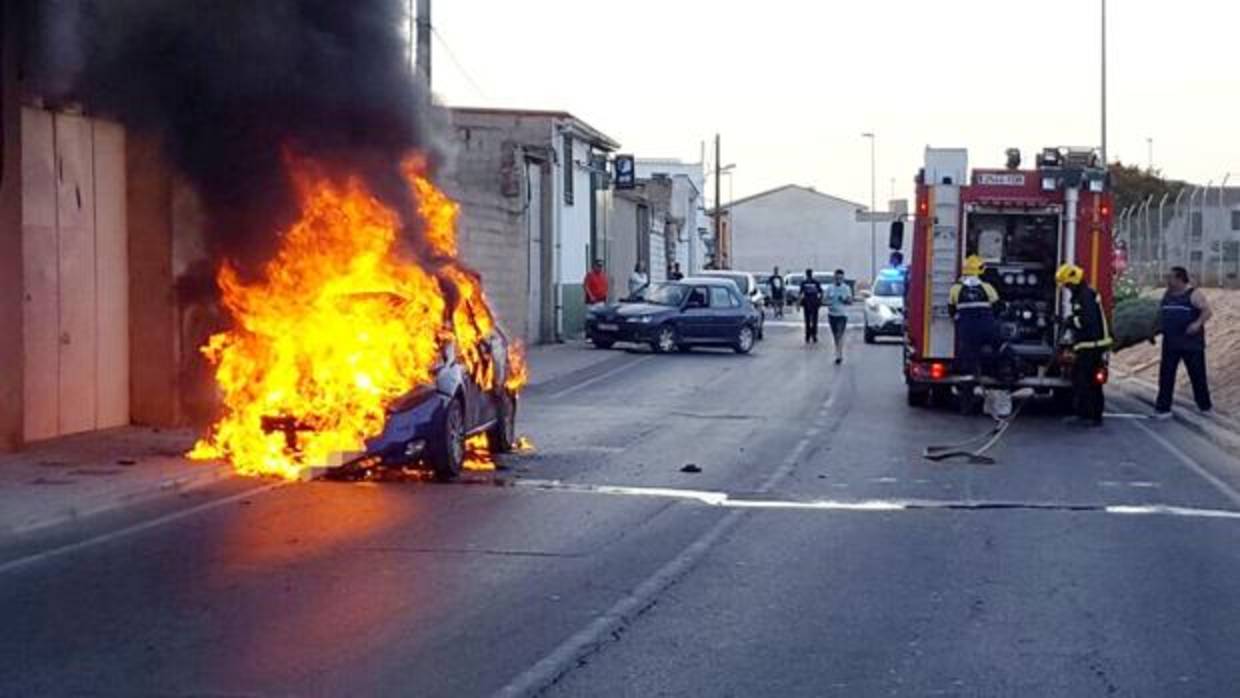 Imágenes de los bomberos apagando las llamas del coche incendiado